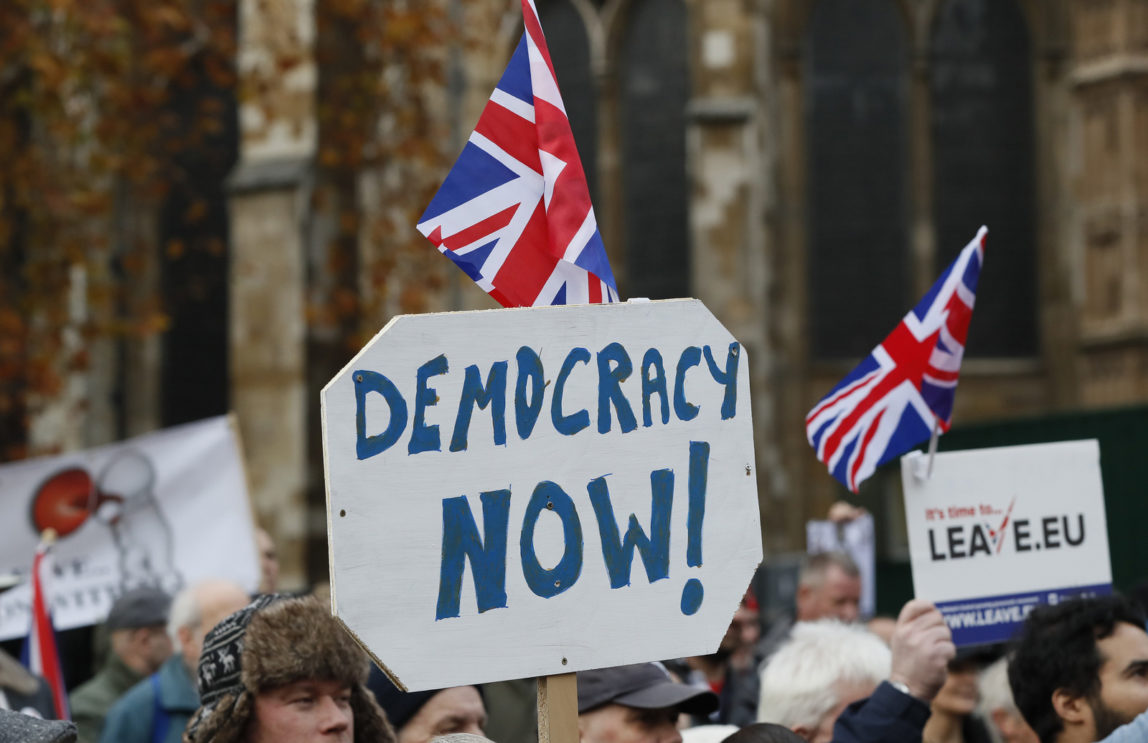 Pro-Brexit demonstrators wave flags and banners outside Parliament in London, Wednesday, Nov. 23, 2016. (AP/Kirsty Wigglesworth)