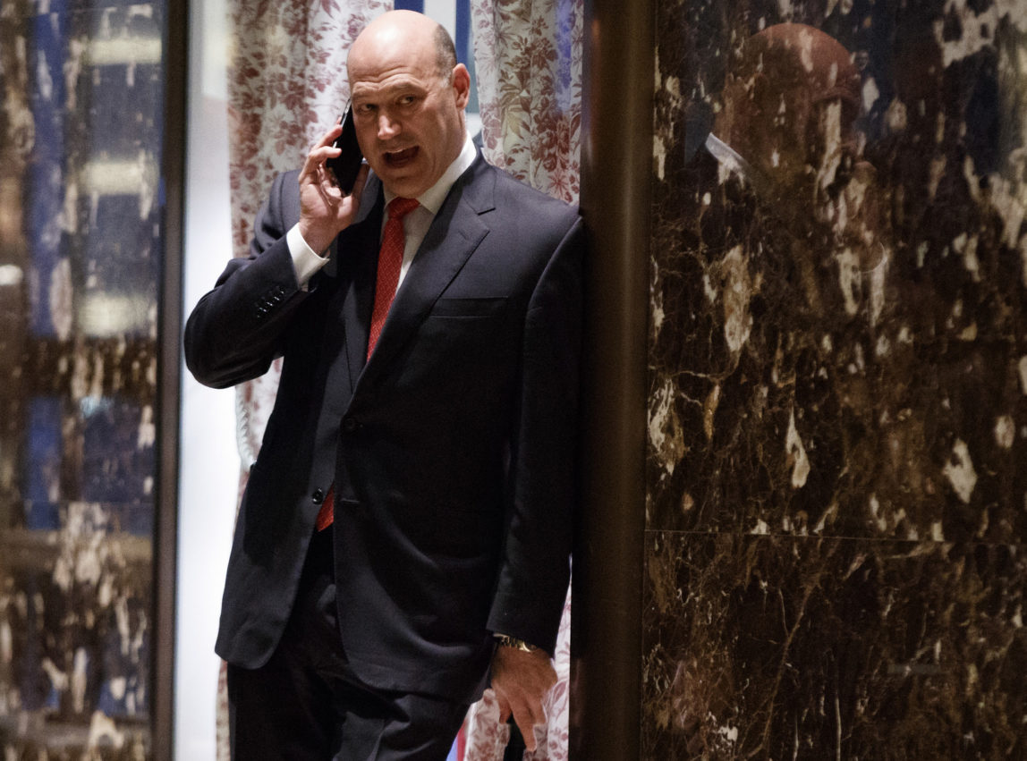 Goldman Sachs COO Gary Cohn talks on the phone as he waits for the start of a meeting with President-elect Donald Trump at Trump Tower, Tuesday, Nov. 29, 2016, in New York. (AP Photo/Evan Vucci)