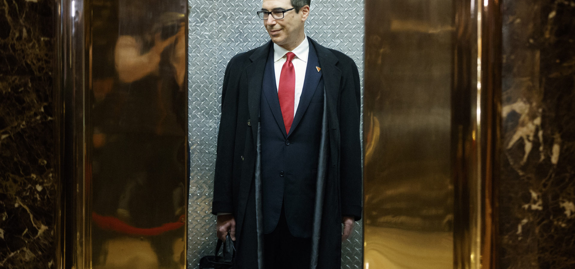 Steven Mnuchin, President-elect Donald Trump's nominee for Treasury Secretary, gets on an elevator after speaking with reporters in the lobby of Trump Tower, Wednesday, Nov. 30, 2016, in New York. (AP Photo/Evan Vucci)