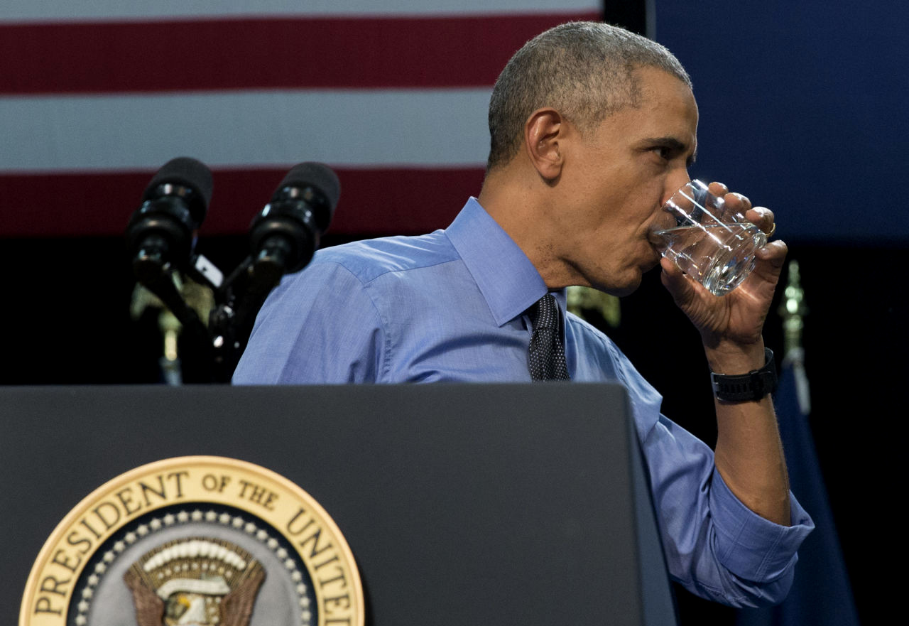 President Barack Obama drinks water as he finishes speaking at Flint Northwestern High School in Flint, Mich., Wednesday, May 4, 2016, about the ongoing water crisis. (AP Photo/Carolyn Kaster)