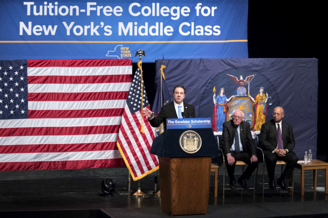 New York Gov. Andrew Cuomo, left, is joined by Vermont Sen. Bernie Sanders, center, and Chairperson of the Board of Trustees of The City University of New York William C. Thompson, as he speaks during an event at LaGuardia Community College, Tuesday, Jan. 3, 2017, in New York. (AP/Mary Altaffer)