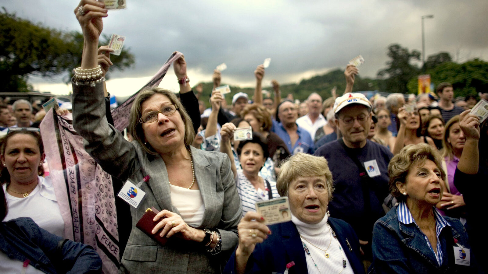 In this Feb. 2009 photo, Venezuelans hold up their ID cards during a protest against anti-semitism outside a synagogue in Caracas, Venezuela following outrage at the 2009 Israeli war on the Gaza Strip. (AP/Ariana Cubillos)