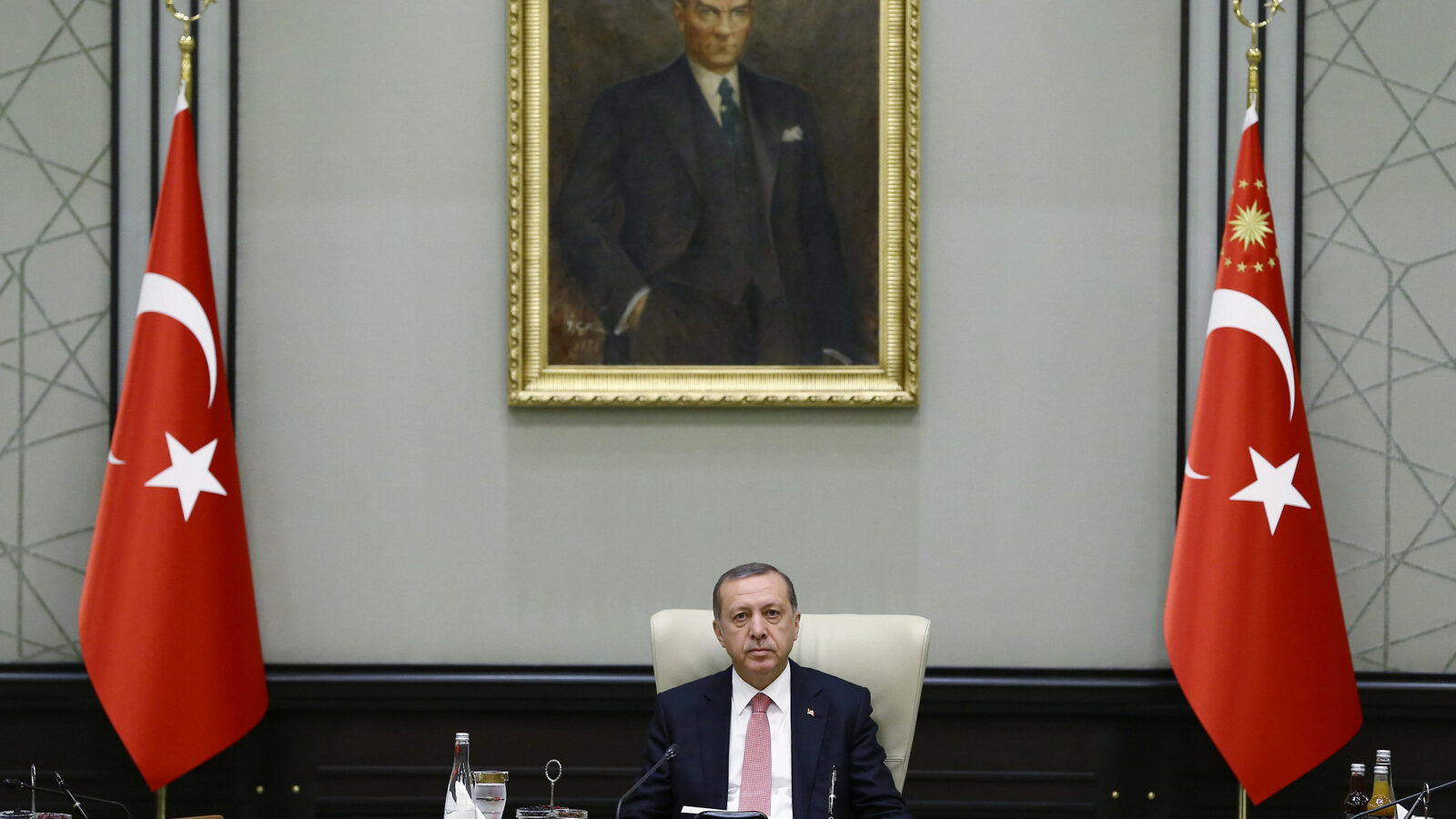 Under a portrait of Turkish Republic founder Mustafa Kemal Ataturk,Turkey's President Recep Tayyip Erdogan chairs the cabinet meeting, in Ankara, Turkey, Monday, July 25, 2016. (Presidential Press Service/AP)
