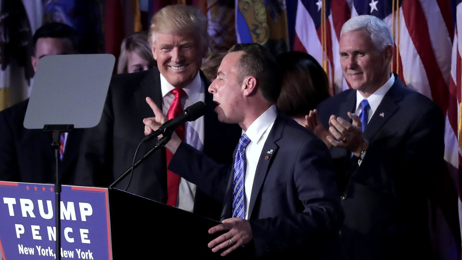 Reince Priebus, Chair of the Republican National Committee, right, speaks as President-elect Donald Trump gives his acceptance speech during his election night rally, Wednesday, Nov. 9, 2016, in New York. (AP/Julie Jacobson)