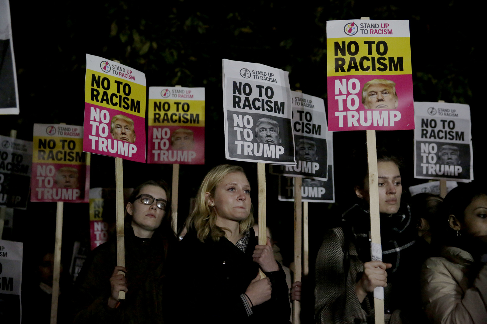 People hold placards as they take part in an anti-racism protest against President-elect Donald Trump winning the American election, outside the U.S. embassy in London, Wednesday, Nov. 9, 2016. (AP/Matt Dunham)