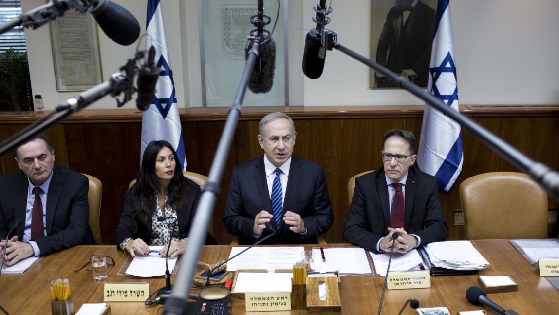 Israeli Prime Minister Benjamin Netanyahu, center, attends the weekly cabinet meeting at his office in Jerusalem, Sunday, Dec. 11, 2016. (Abir Sultan, Pool via AP)