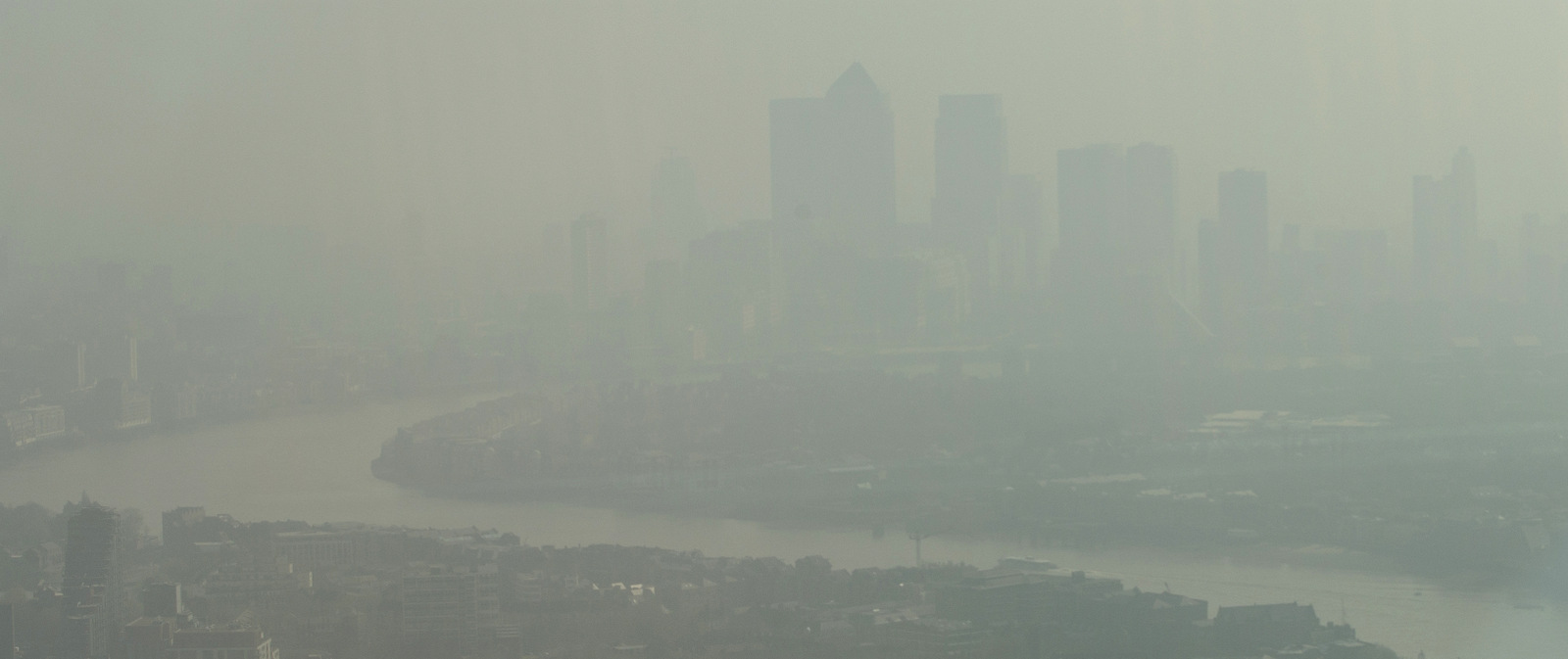 In this general view of London looking towards Canary Wharf which is just visible through the haze and smog in London, Friday, April 10, 2015. (AP/Alastair Grant)