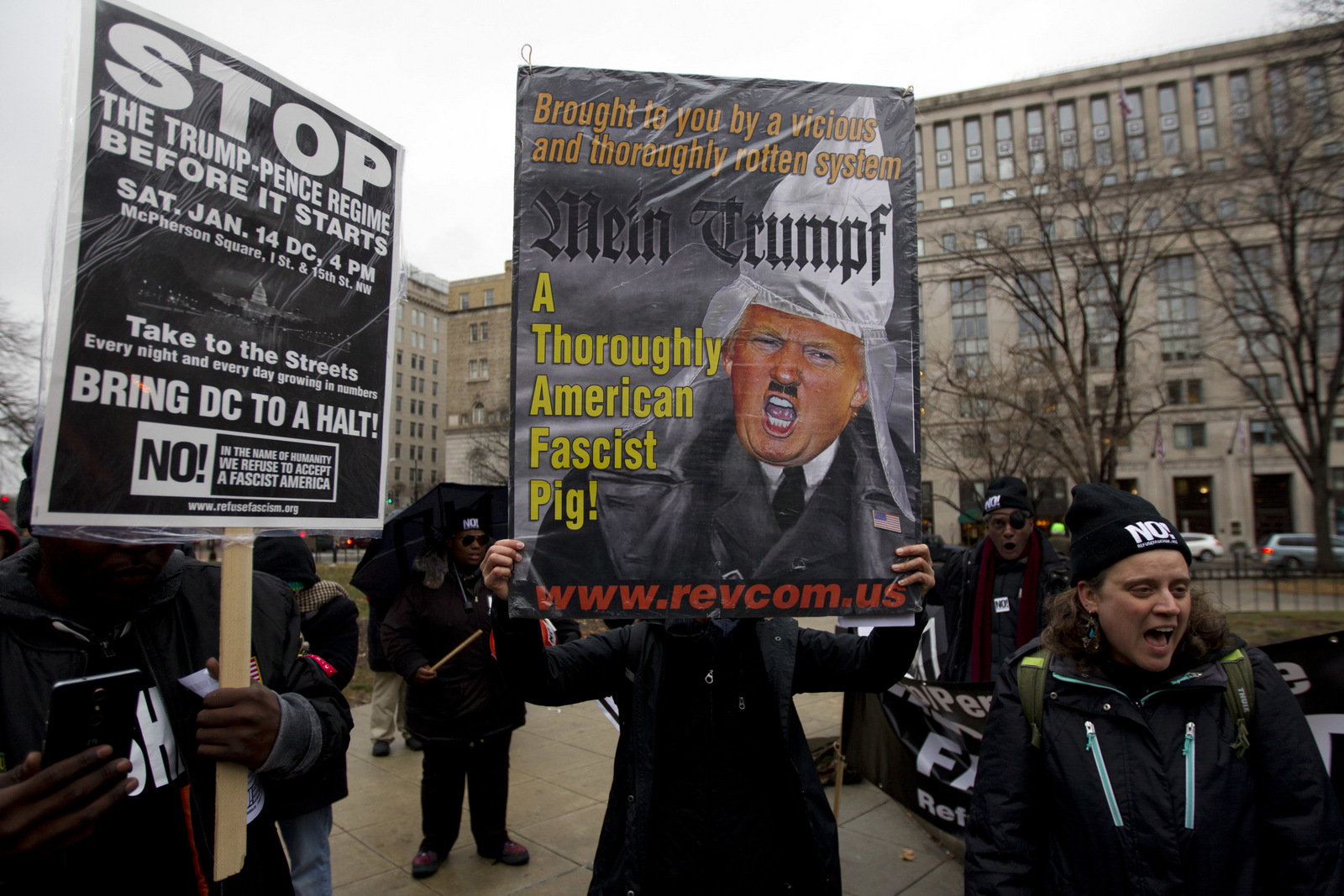 Demonstrators hold banners as they protest in opposition of President-elect Donald Trump, at McPherson Square, in Washington, Saturday, Jan. 14, 2017. ( AP/Jose Luis Magana)