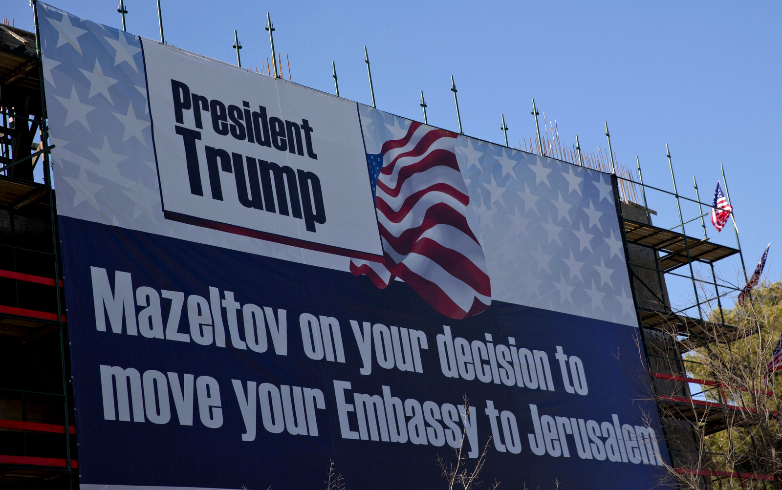 A sign hangs on a building under construction in Jerusalem congratulating U.S. President Donald Trump, Friday, Jan. 20, 2017. Trump has vowed to move the U.S. embassy from Tel Aviv to Jerusalem. (AP/Ariel Schalit)