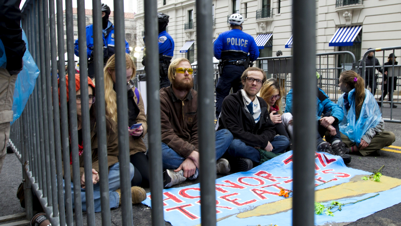 Demonstrators sit at the entrance of a security checkpoint, to block people to enter, Friday, Jan. 20, 2017, during the inauguration of President Donald Trump in Washington. ( AP/Jose Luis Magana)