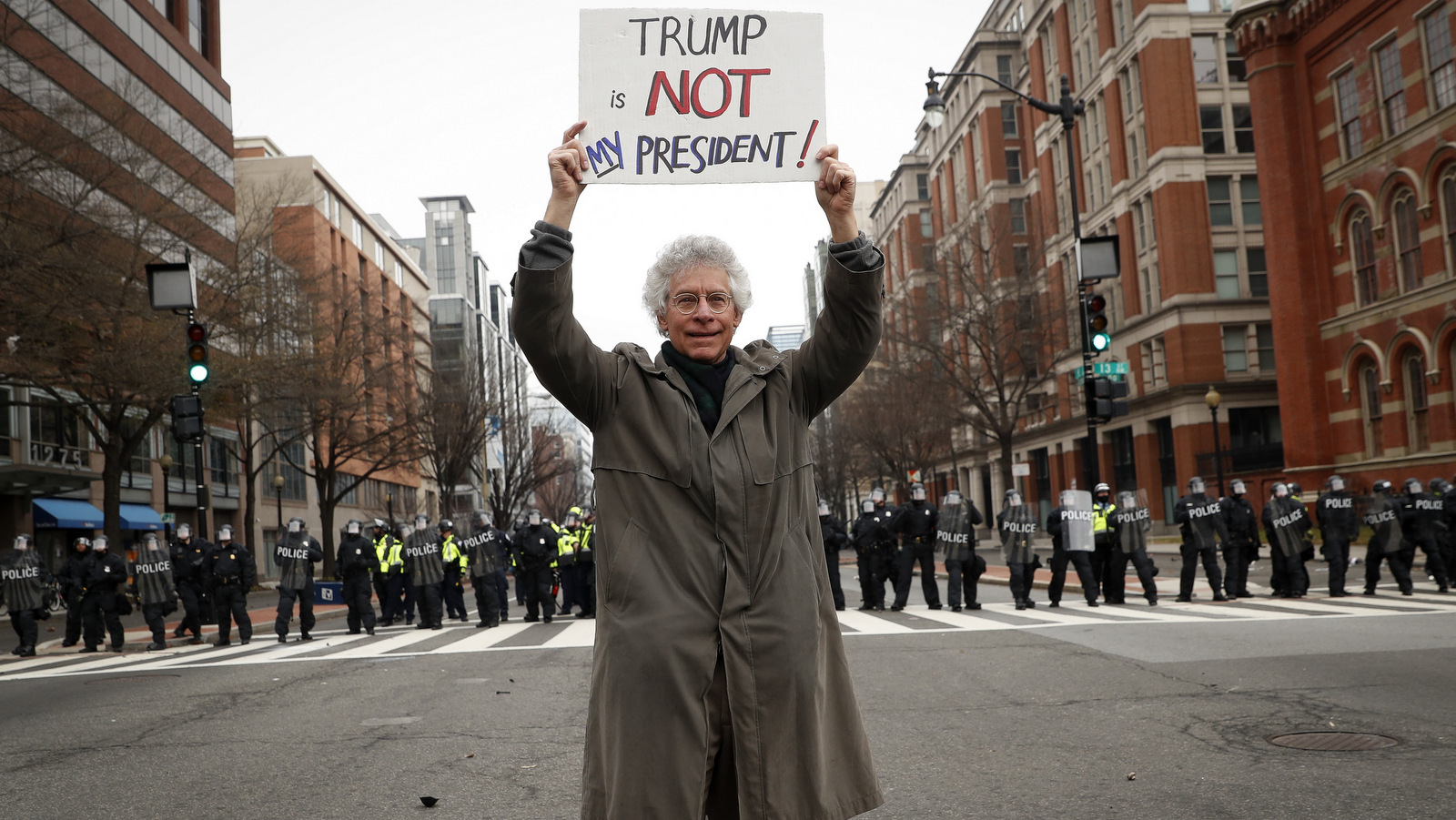 A protester stands in front of a riot police line during a demonstration after the inauguration of President Donald Trump, Friday, Jan. 20, 2017, in Washington. (AP/John Minchillo)