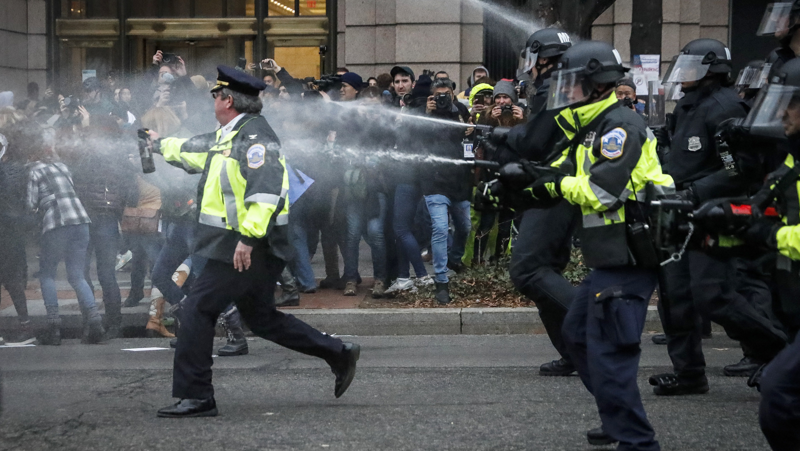 Police fire pepper spray on protestors during a demonstration after the inauguration of President Donald Trump, Friday, Jan. 20, 2017, in Washington. (AP/John Minchillo)