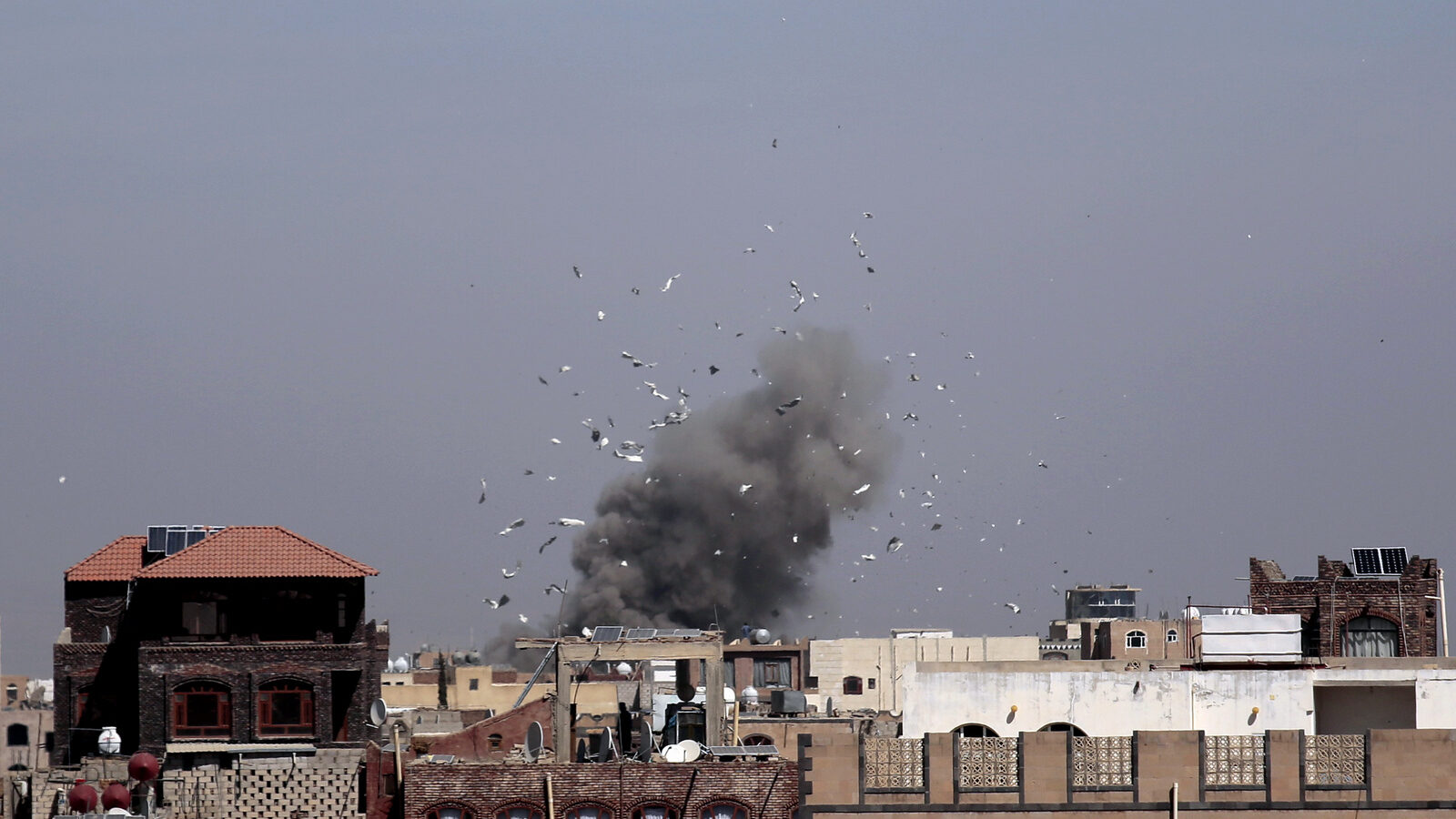 Debris and smoke rise after a Saudi-led airstrike hit an army base, in Sanaa, Yemen, Sunday, Jan. 22, 2017. (AP/Hani Mohammed)