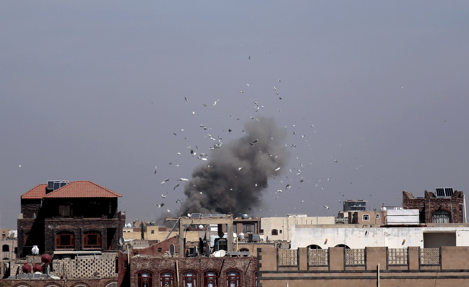 Debris and smoke rise after a Saudi-led airstrike hit an army base, in Sanaa, Yemen, Sunday, Jan. 22, 2017. (AP/Hani Mohammed)