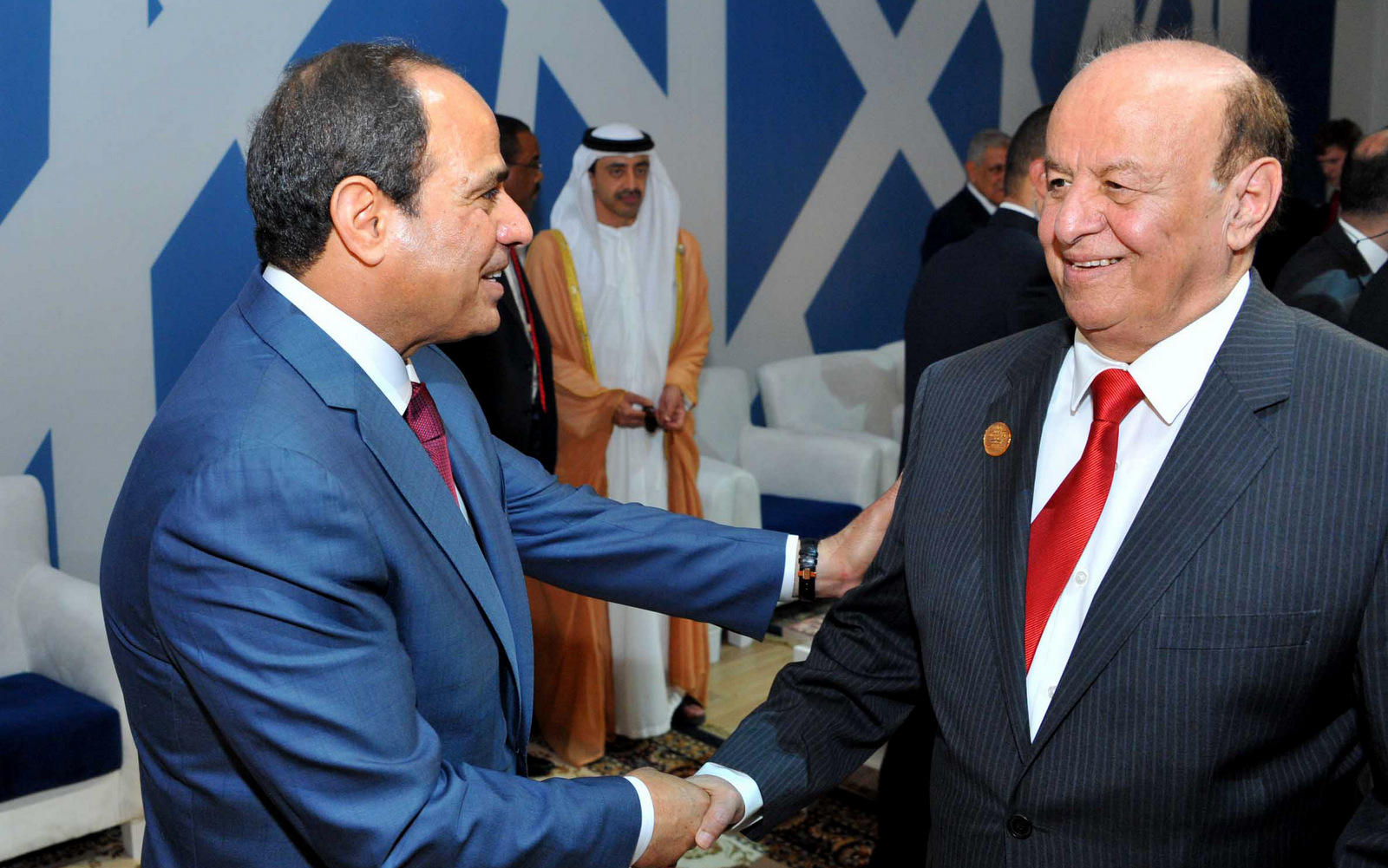 In this picture provided by the office of the Egyptian Presidency, Egyptian President Abdel-Fattah el-Sissi, left, talks to Yemen's exiled President Abed Rabbo Mansour Hadi following a ceremony unveiling a major extension of the Suez Canal in Ismailia, Egypt,, Aug. 6, 2015. (Egyptian Presidency via AP)