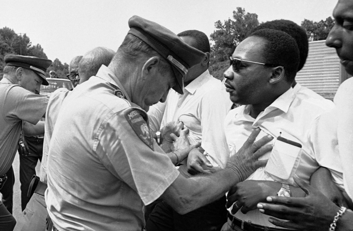 Mississippi Highway Patrolmen shove the Rev. Martin Luther King and members of his marching group off the traffic lane of Highway 51 south of Hernando, Miss., June 7, 1966. (AP Photo)