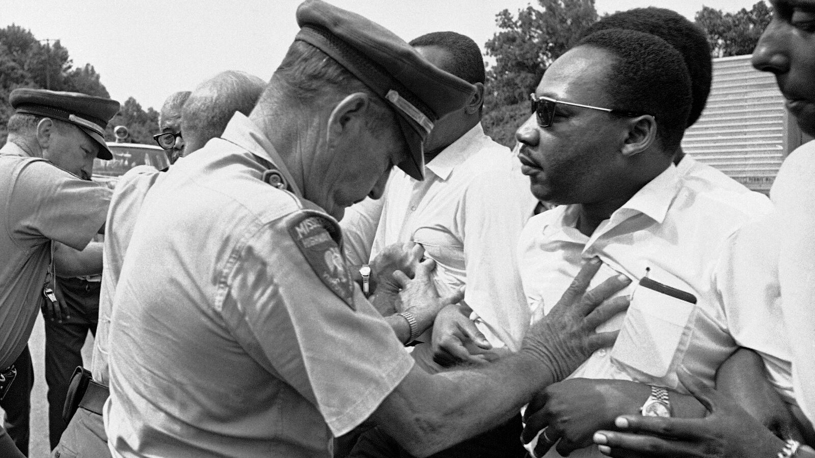 Mississippi Highway Patrolmen shove the Rev. Martin Luther King and members of his marching group off the traffic lane of Highway 51 south of Hernando, Miss., June 7, 1966. (AP Photo)