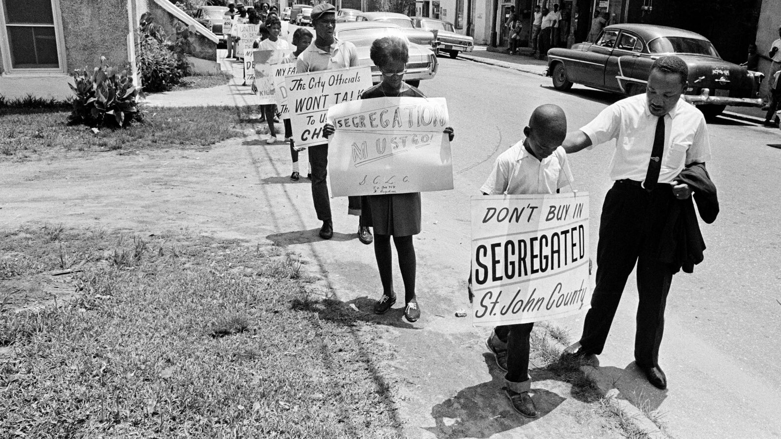 Dr. Martin Luther King, Jr. gives a young picket a pat on the back as a group of youngsters started to picket St. Augustine, Fla., June 10, 1964. (AP Photo)