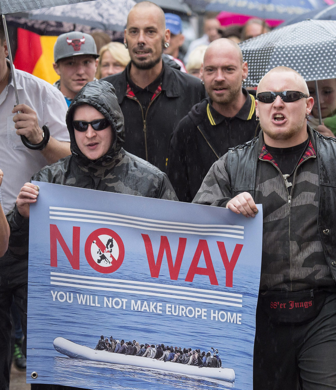 People take part at a demonstration initiated by right-wing NPD (National Democratic Party of Germany) against the German asylum law and asylum seekers in Riesa, eastern Germany, Tuesday, Aug. 18, 2015. (AP/Jens Meyer)