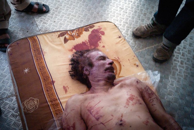 The body of deposed Libyan leader Moammar Gadhafi lies on a mattress in a commercial freezer at a shopping center in Misrata, Libya, Friday, Oct. 21, 2011. (AP/David Sperry)