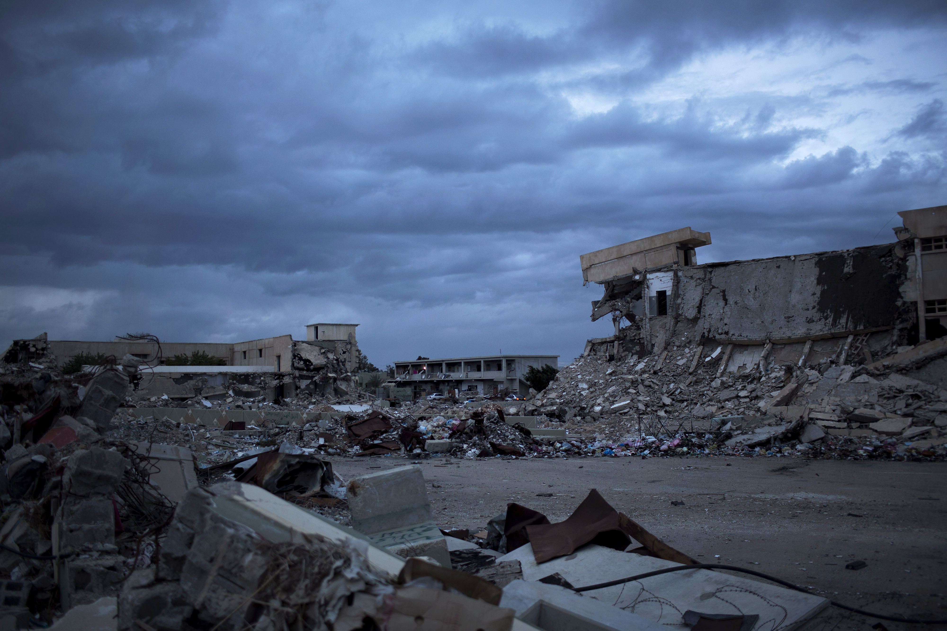 This Tuesday, Nov. 26, 2013 photo shows a general view of buildings destroyed by NATO bombing of the Bab Al-Aziziya compound and an occupied intact building in Tripoli, Libya. (AP/Manu Brabo)