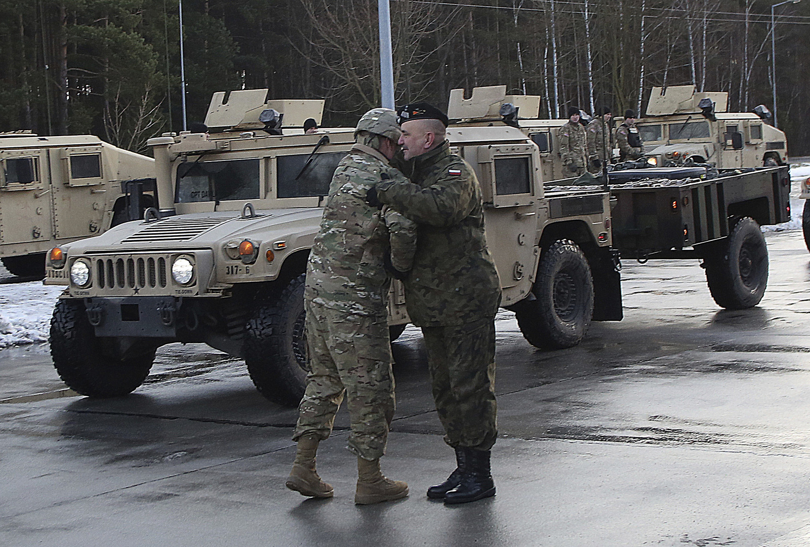 A U.S. soldier is welcomed by a Polish army official as U.S. Army vehicles cross the Polish border in Olszyna, Poland, Thursday, Jan. 12, 2017 heading for their new base in Zagan. (AP/Czarek Sokolowski)