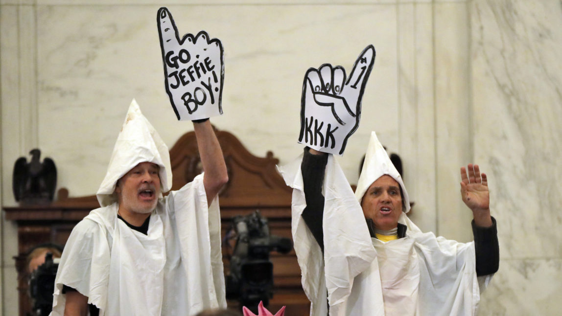 Demonstrators are seen on Capitol Hill in Washington, Tuesday, Jan. 10, 2017, during the Senate Judiciary Committee's confirmation hearing for Attorney General-designate, Sen. Jeff Sessions, R-Ala. (AP/Andrew Harnik)