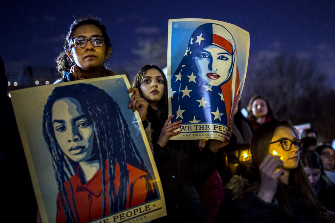Protesters listen to an speaker as the hold signs during a rally against President Donald Trump's order cracking down on immigrants living in the US at Washington Square Park in New York, Wednesday, Jan. 25, 2017. (AP/Andres Kudacki)