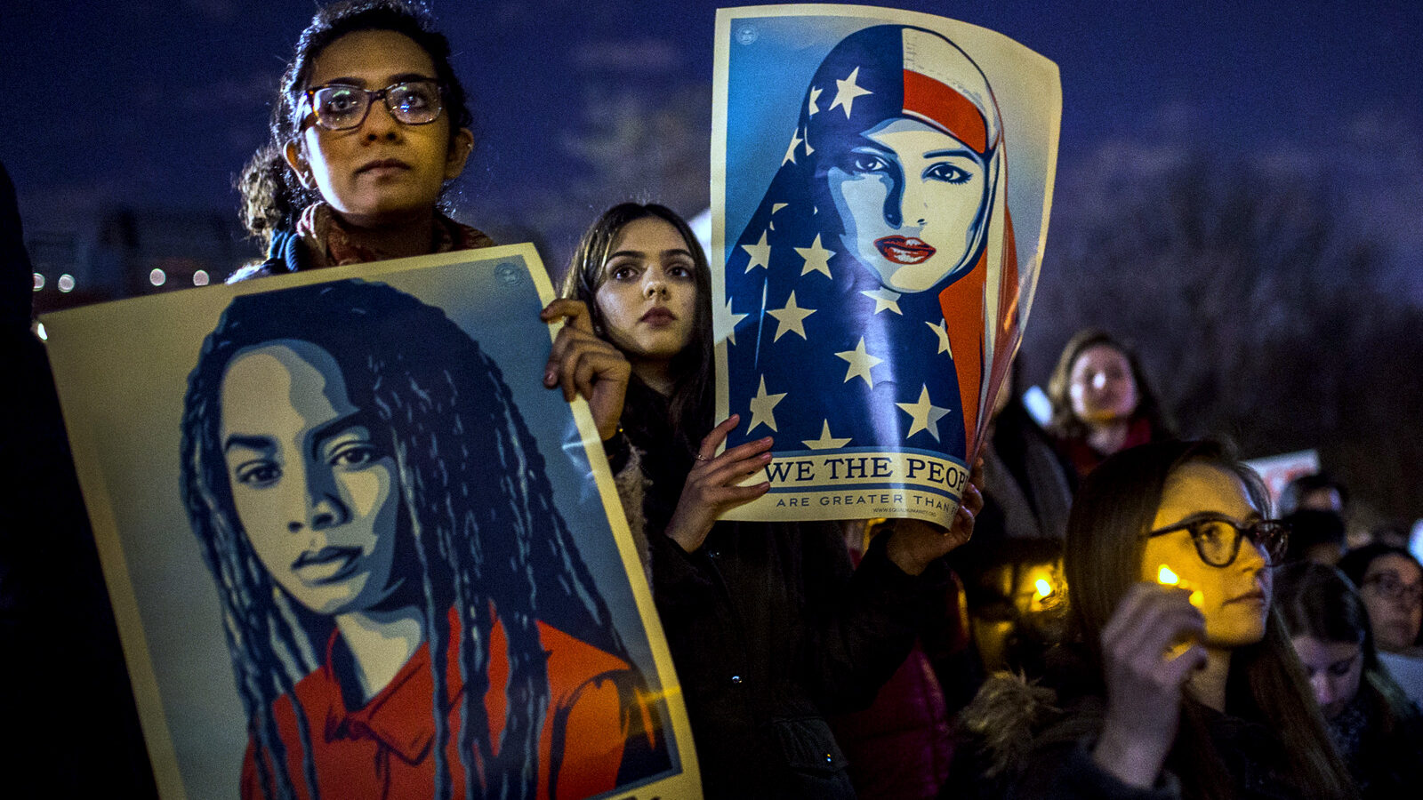 Protesters listen to an speaker as the hold signs during a rally against President Donald Trump's order cracking down on immigrants living in the US at Washington Square Park in New York, Wednesday, Jan. 25, 2017. (AP/Andres Kudacki)