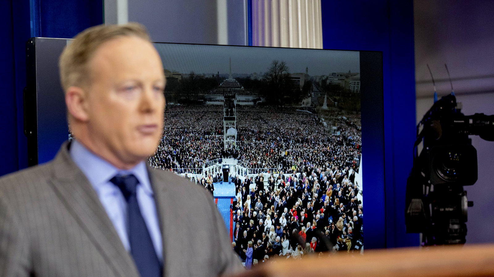 An image of the inauguration of President Donald Trump is displayed behind White House press secretary Sean Spicer as he speaks at the White House, Saturday, Jan. 21, 2017, in Washington. (AP/Andrew Harnik)