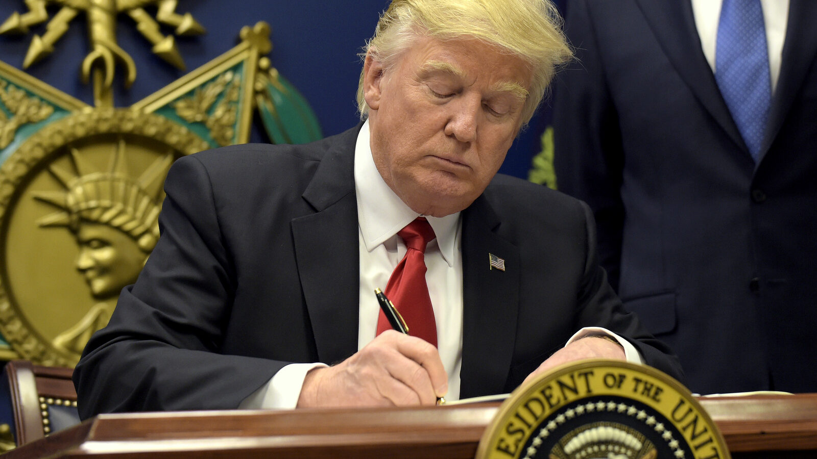 President Donald Trump signs an executive order on 'extreme vetting' during an event at the Pentagon in Washington, Friday, Jan. 27, 2017. (AP/Susan Walsh)