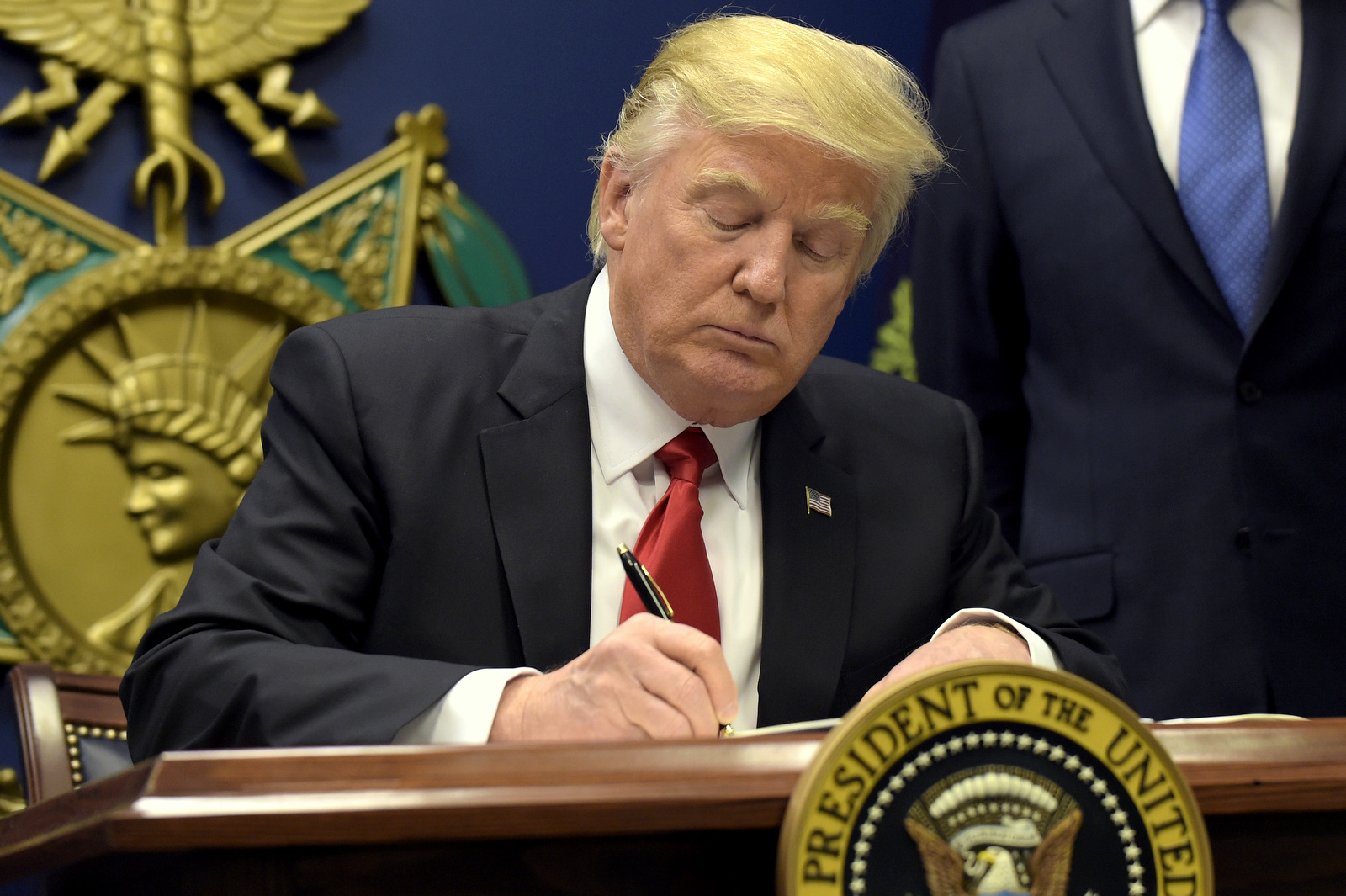 President Donald Trump signs an executive order on 'extreme vetting' during an event at the Pentagon in Washington, Friday, Jan. 27, 2017. (AP/Susan Walsh)