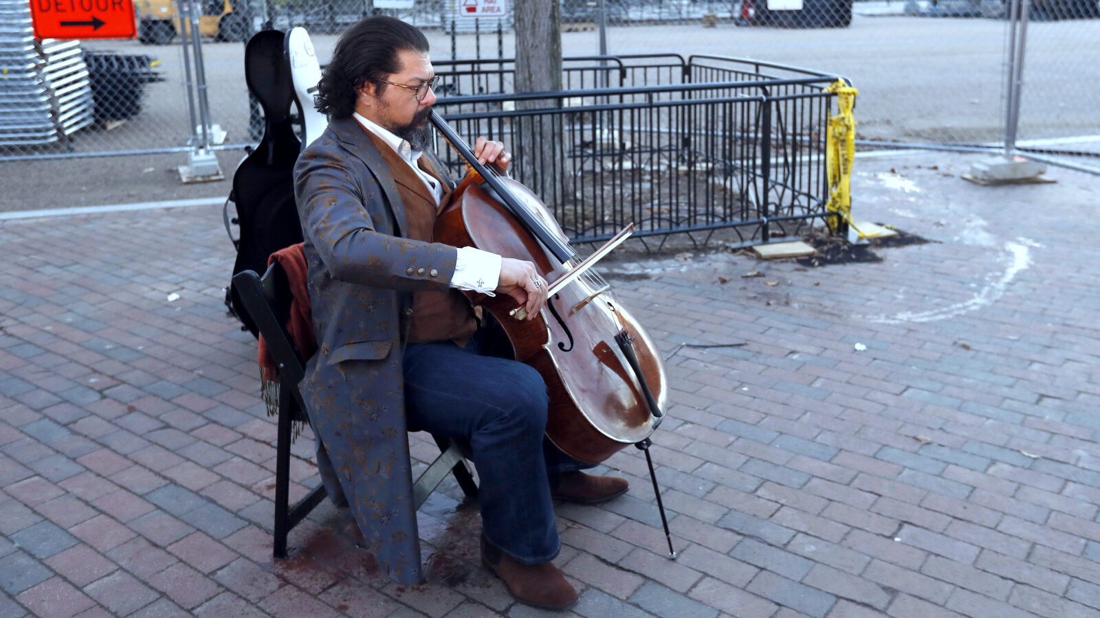 Karim Wasfi, the former conductor of the Baghdad Symphony, plays his cello is Lafayette Park near a protest about President Donald Trump's immigration policies, Wednesday, Jan. 25, 2017 in Washington. (AP/Alex Brandon)