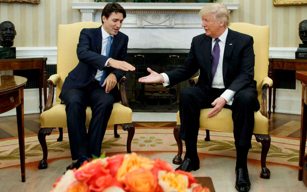 President Donald Trump reaches to shakes hands with Canadian Prime Minister Justin Trudeau in the Oval Office of the White House in Washington, Monday, Feb. 13, 2017. (Photo: Evan Vucci/AP)