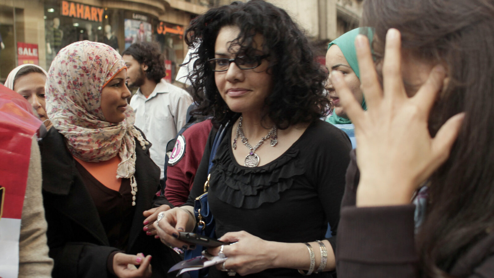 Egyptian activist Samira Ibrahim, left, and Mona Eltahawy, a prominent Egyptian-born U.S. columnist, center, march in downtown Cairo, Egypt to mark International Women's Day Thursday, March 8, 2012. (AP/Maya Alleruzzo)