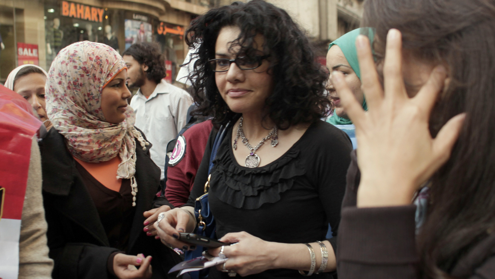 Egyptian activist Samira Ibrahim, left, and Mona Eltahawy, a prominent Egyptian-born U.S. columnist, center, march in downtown Cairo, Egypt to mark International Women's Day Thursday, March 8, 2012. (AP/Maya Alleruzzo)