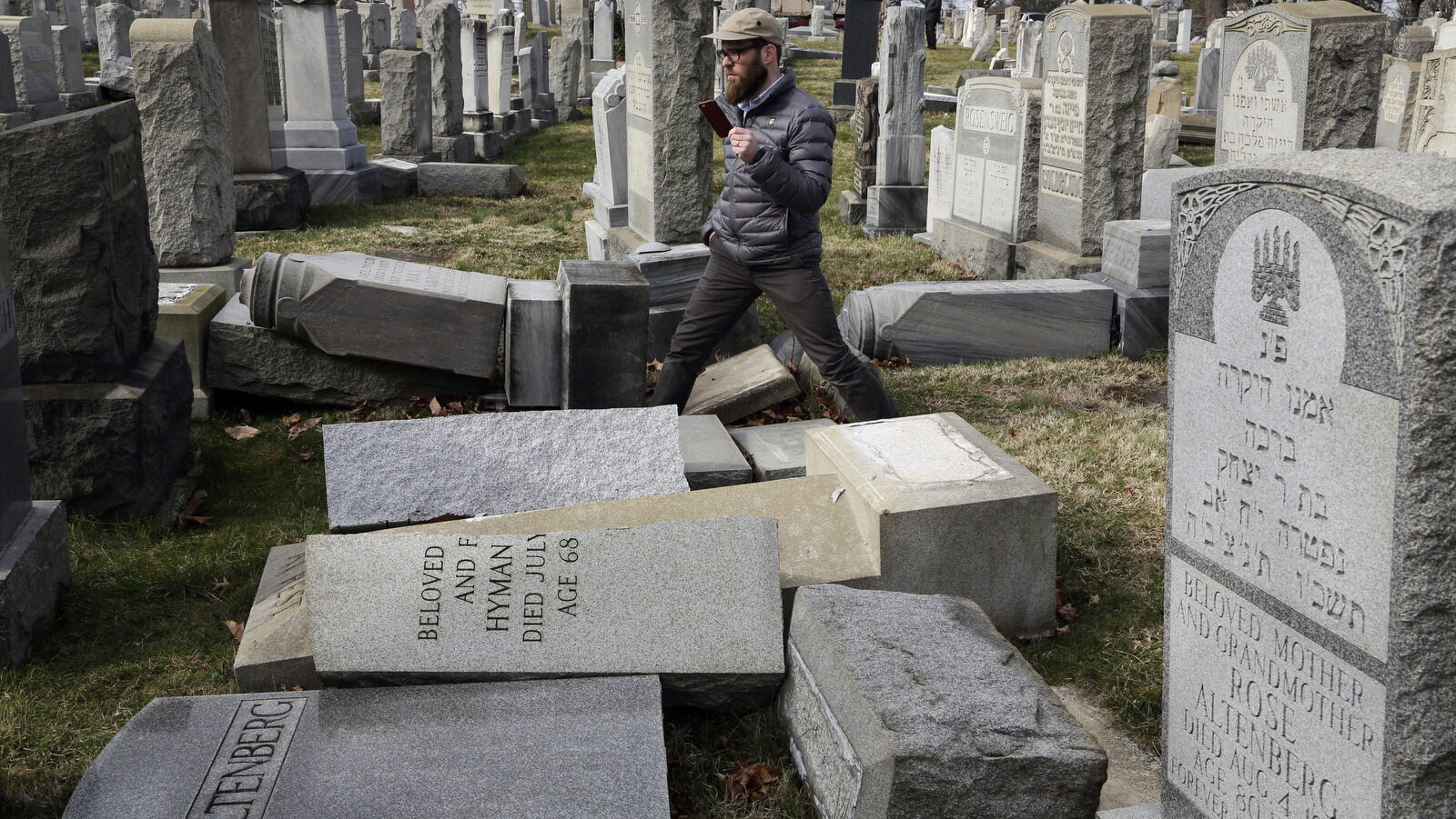 Rabbi Joshua Bolton of the University of Pennsylvania's Hillel center surveys damaged headstones at Mount Carmel Cemetery on Monday, Feb. 27, 2017, in Philadelphia. More than 100 headstones have been vandalized at the Jewish cemetery in Philadelphia, damage discovered less than a week after similar vandalism in Missouri, authorities said. (AP/Jacqueline Larma)
