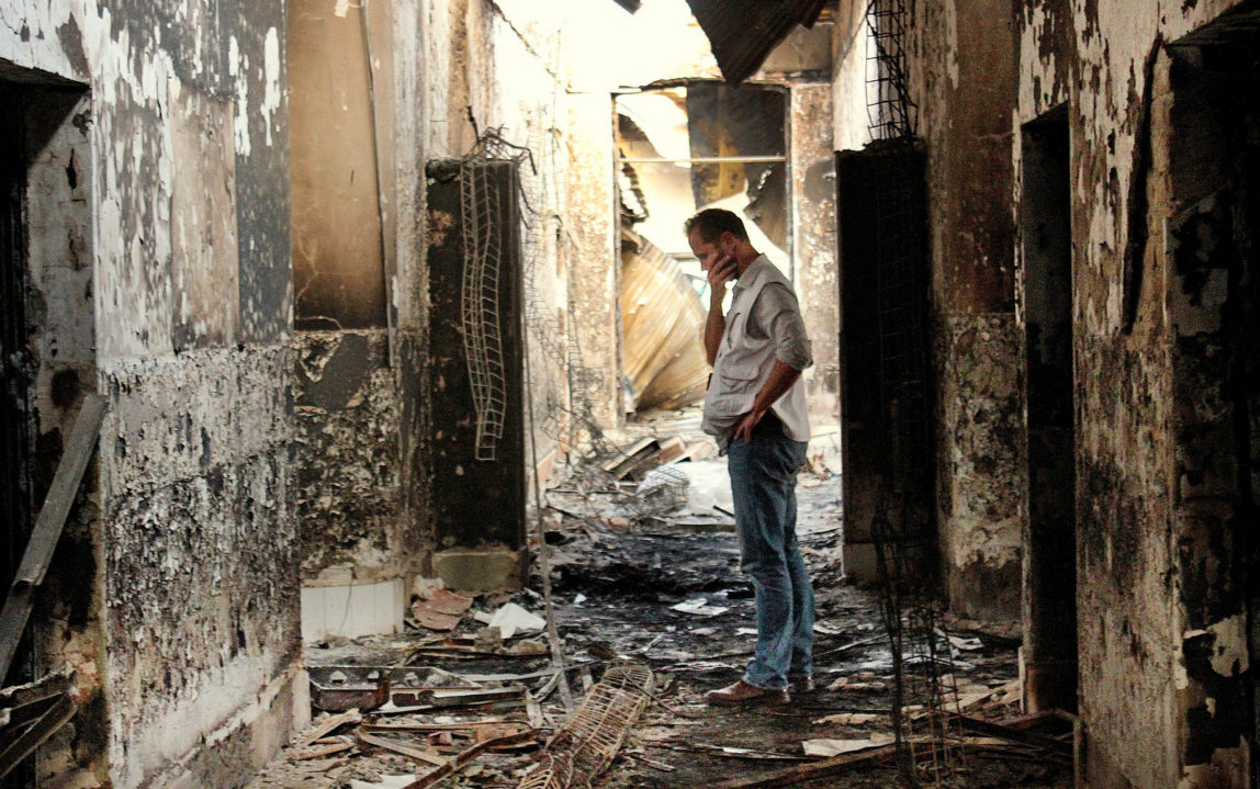 An employee of Doctors Without Borders, MSF, walks inside the charred remains of the organization's hospital after it was hit by a U.S. airstrike in Kunduz, Afghanistan. (AP/Najim Rahim)