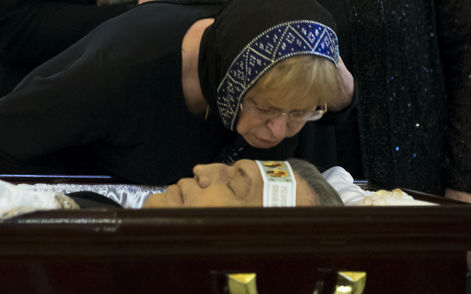 The widow of Andrei Karlov Marina kisses her husband during a religious service for killed Russian ambassador to Turkey, Andrei Karlov inside the Christ the Saviour Cathedral in Moscow, Russia, Thursday, Dec. 22, 2016.(AP/Alexander Zemlianichenko)