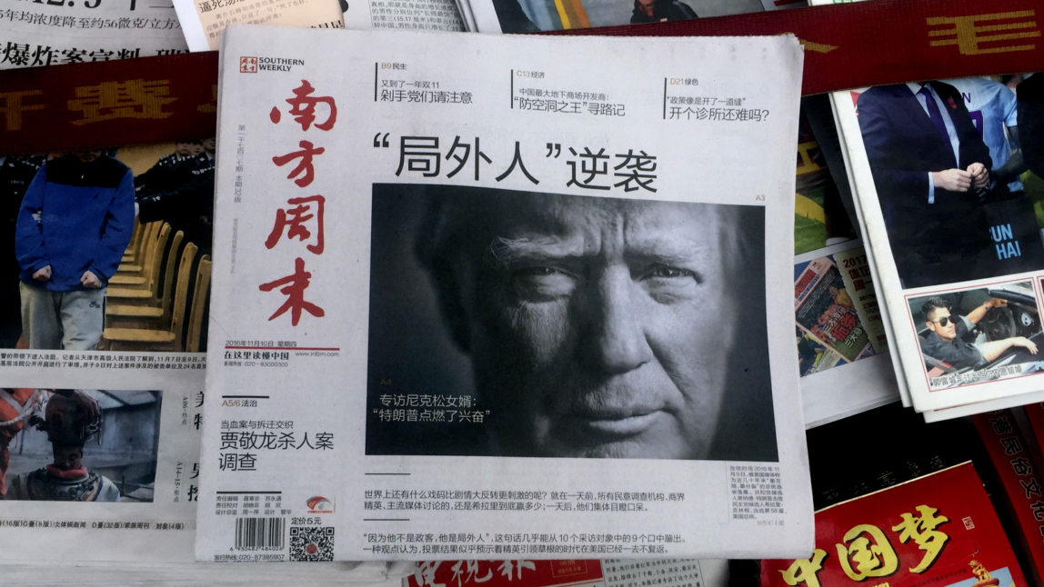 A front page of a Chinese newspaper with a photo of U.S. President-elect Donald Trump and the headline "Outsider counter attack" is displayed at a newsstand in Beijing, (AP/Ng Han Guan)