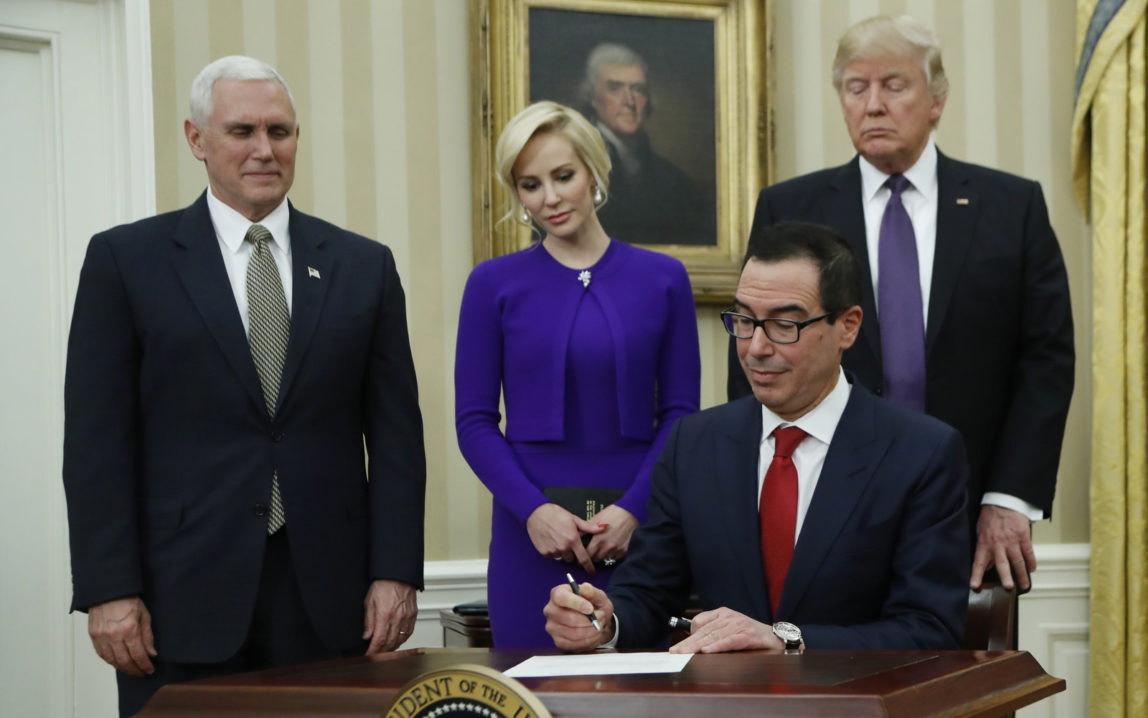President Donald Trump, right, Vice President Mike Pence, left, witness Treasury Secretary Steven Mnuchin accompanied by his fiancée Louise Linton sign documents after he was sworn-in by the vice president, Monday, Feb. 13, 2017. (AP/Manuel Balce Ceneta)
