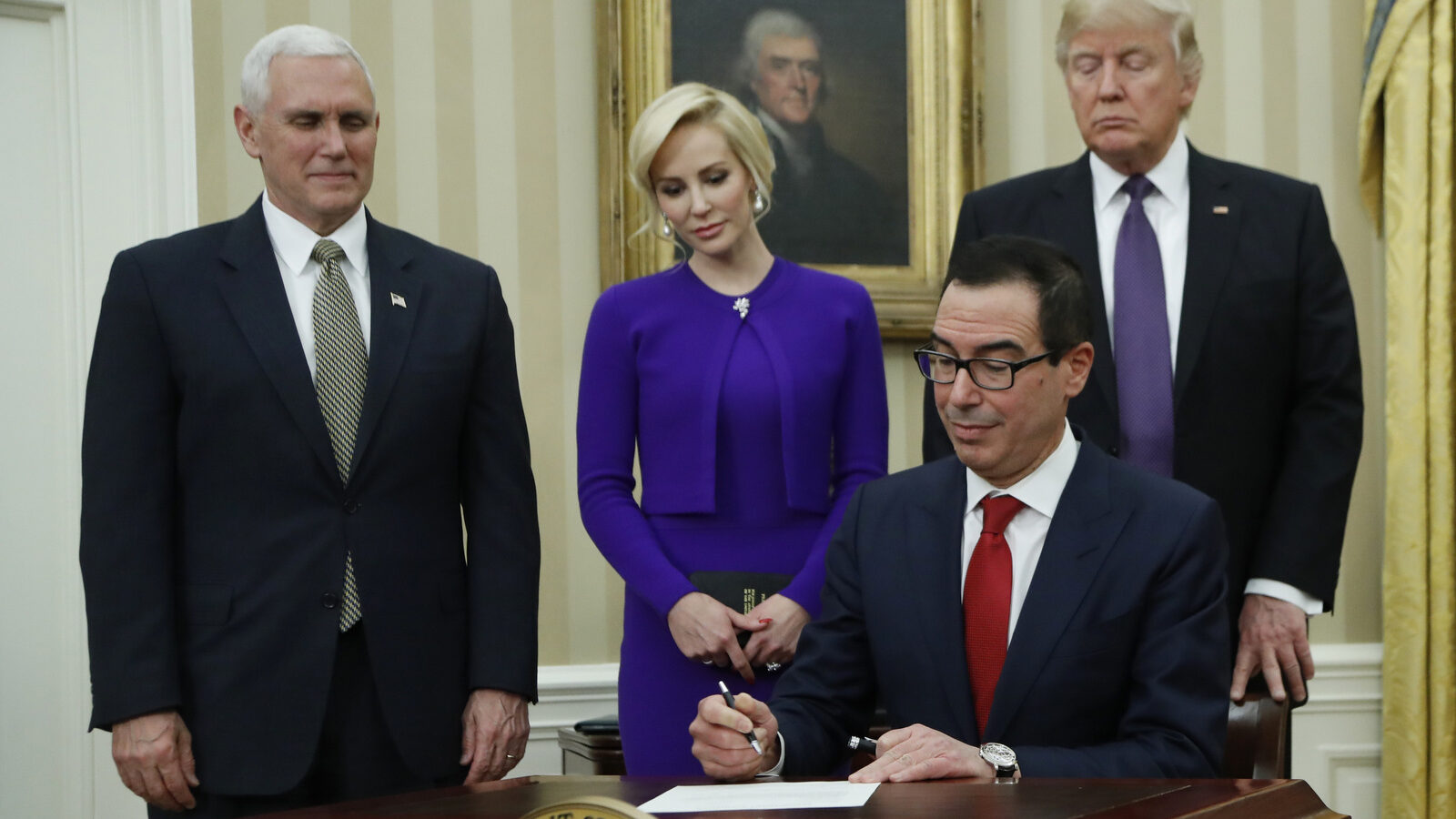 President Donald Trump, right, Vice President Mike Pence, left, witness Treasury Secretary Steven Mnuchin accompanied by his fiancée Louise Linton sign documents after he was sworn-in by the vice president, Monday, Feb. 13, 2017. (AP/Manuel Balce Ceneta)