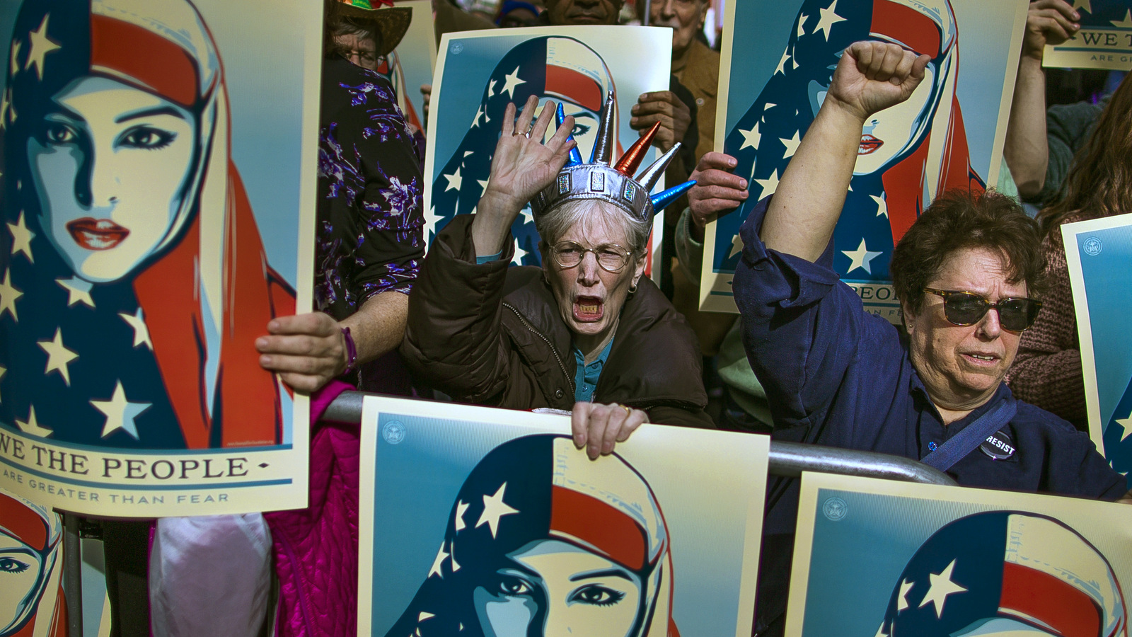 People carry posters during a rally against President Donald Trump's executive order banning travel from seven Muslim-majority nations, in New York's Times Square, Sunday, Feb. 19, 2017. (AP/Andres Kudacki)