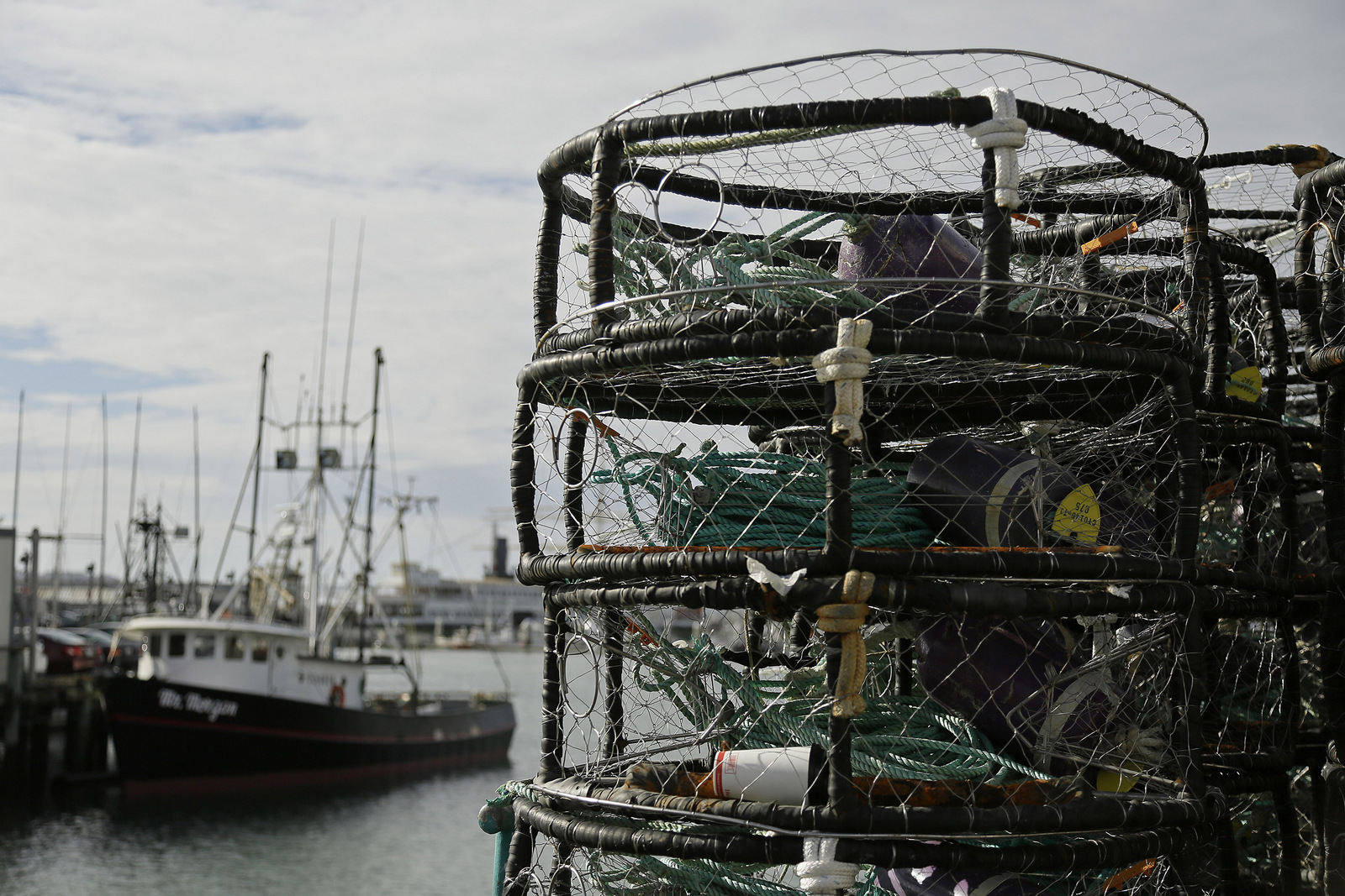 Crab pots are stacked along a pier at Fisherman's Wharf, Thursday, Nov. 5, 2015, in San Francisco after authorities delayed the Dungeness crab season and closed the rock crab fishery for most of California days after warning of dangerous levels of a neurotoxin found off the coast. (AP/Eric Risberg)
