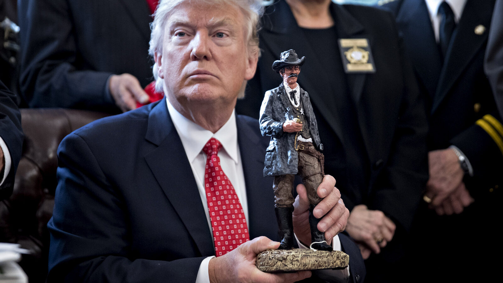 U.S. President Donald Trump holds up a statue he received as a gift while meeting with county sheriffs in the Oval Office of the White House in Washington, D.C., U.S., on Tuesday, Feb. 7, 2017. (Photo: Andrew Harrer/CNP/MediaPunch/IPX)