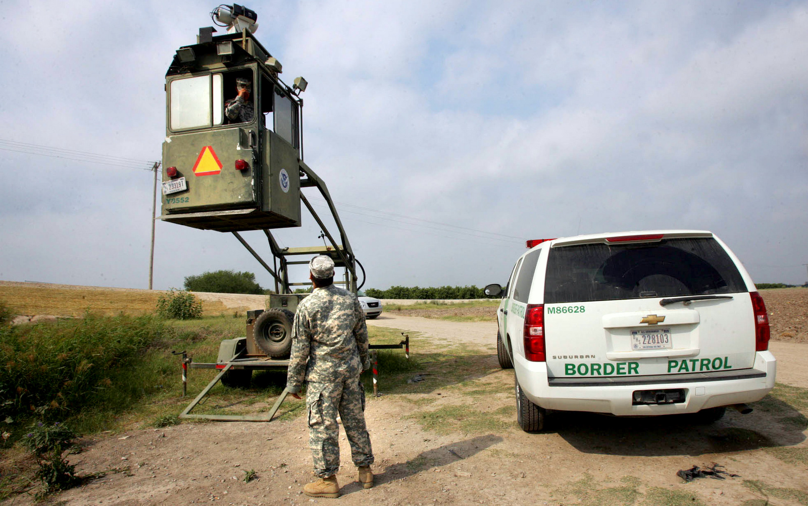 A member of the National Guard checks on his colleague inside a Border Patrol Skybox near the Hidalgo International Bridge in Hidalgo, Texas.  (AP/Delcia Lopez)
