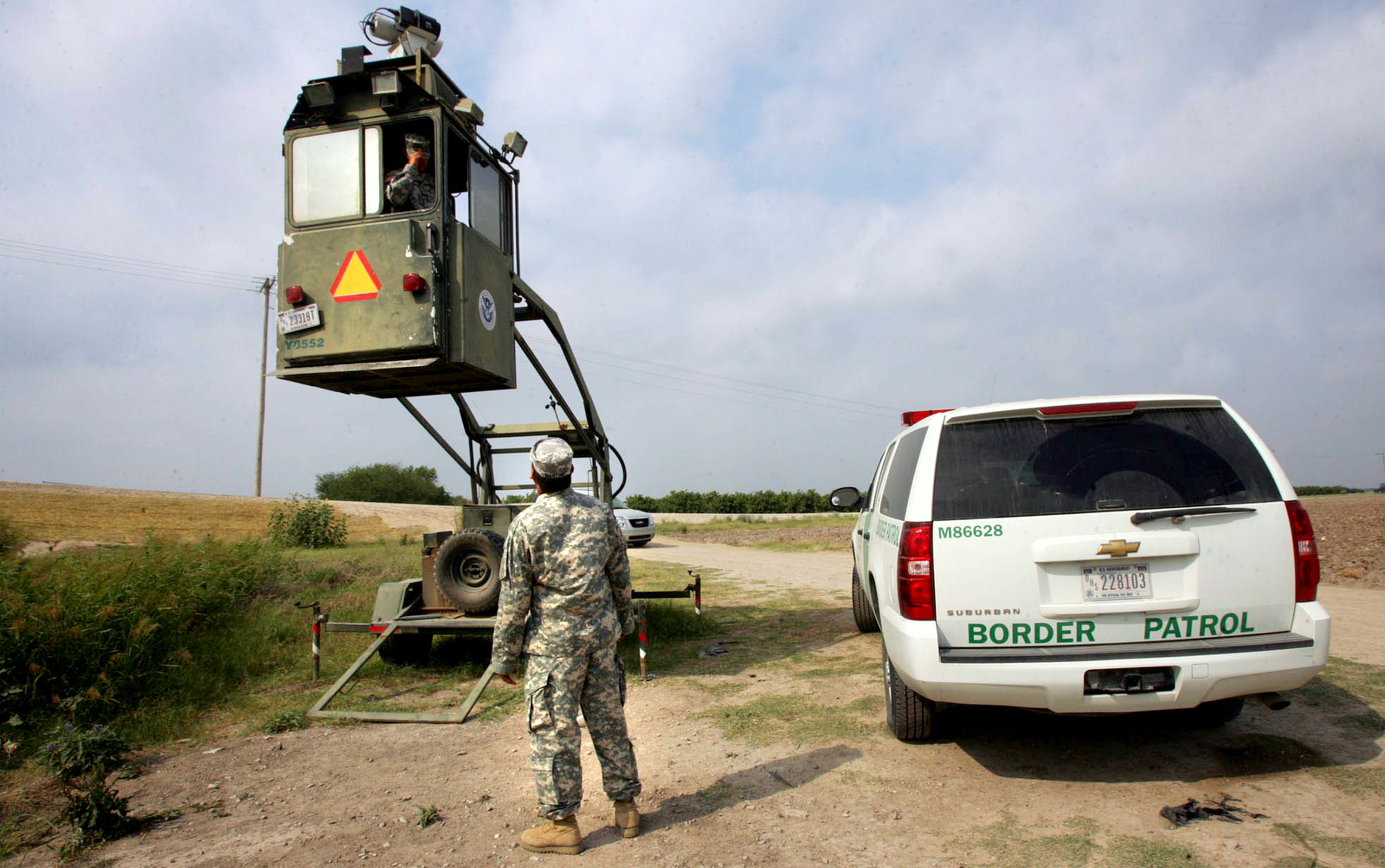 A member of the National Guard checks on his colleague inside a Border Patrol Skybox near the Hidalgo International Bridge in Hidalgo, Texas. (AP/Delcia Lopez)