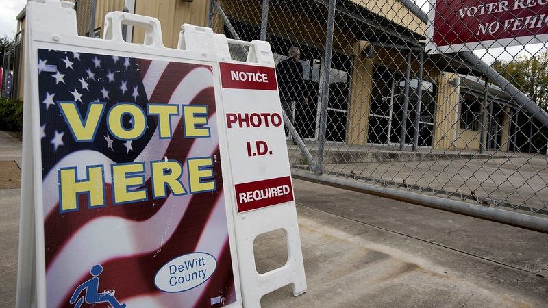 During the first week of early voting for the 2016 presidential elections, civil rights lawyers took issue with this sign outside of a polling place in Cuero. It did not mention options for casting a ballot without photo ID. (Photo: Bob Daemmrich /The Texas Tribune)
