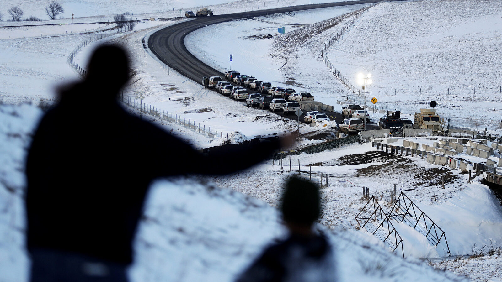 Law enforcement vehicles line a road leading to a blocked bridge next to the Oceti Sakowin camp where people have gathered to protest the Dakota Access oil pipeline in Cannon Ball, N.D. (AP/David Goldman)