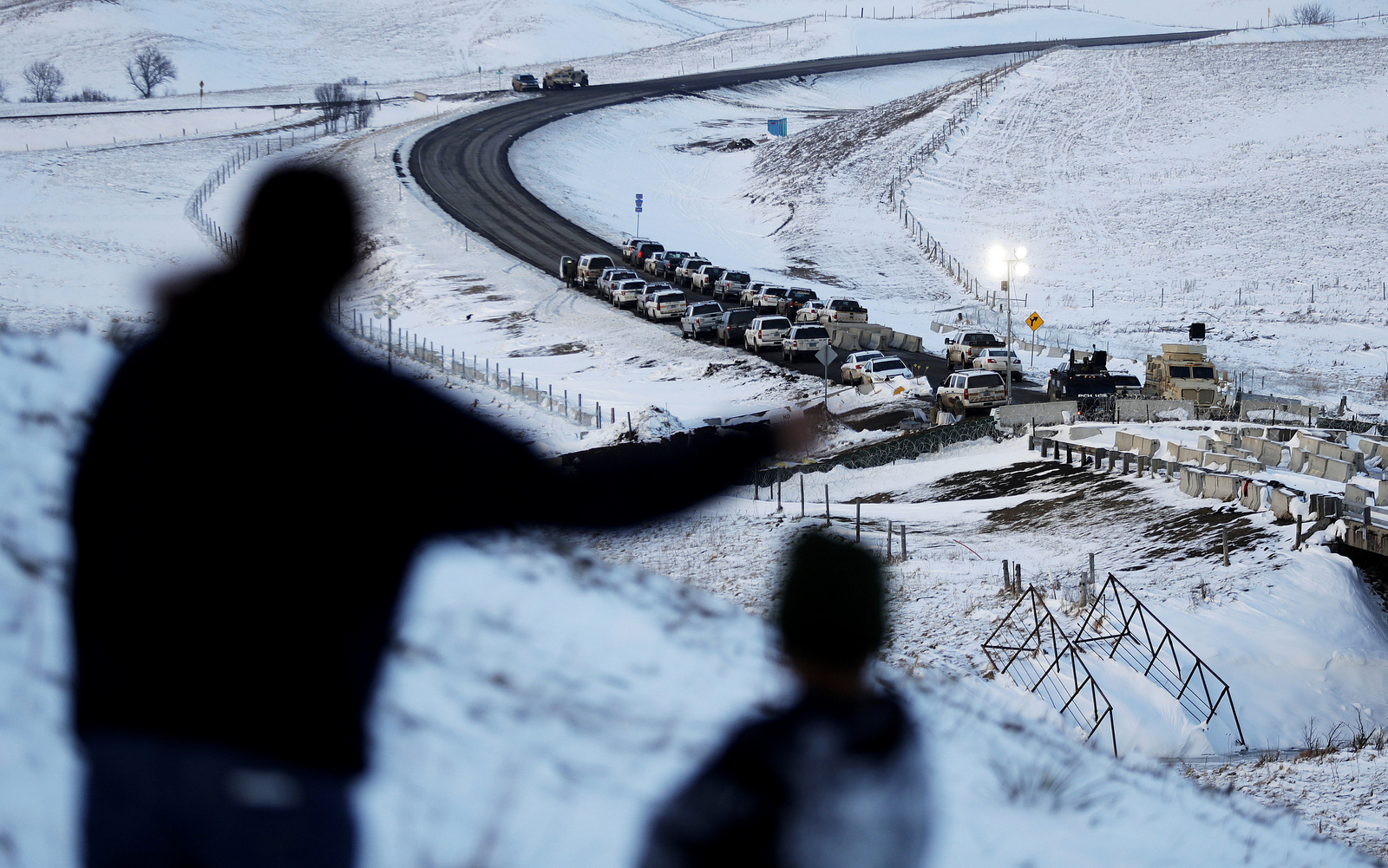 Law enforcement vehicles line a road leading to a blocked bridge next to the Oceti Sakowin camp where people have gathered to protest the Dakota Access oil pipeline in Cannon Ball, N.D. (AP/David Goldman)